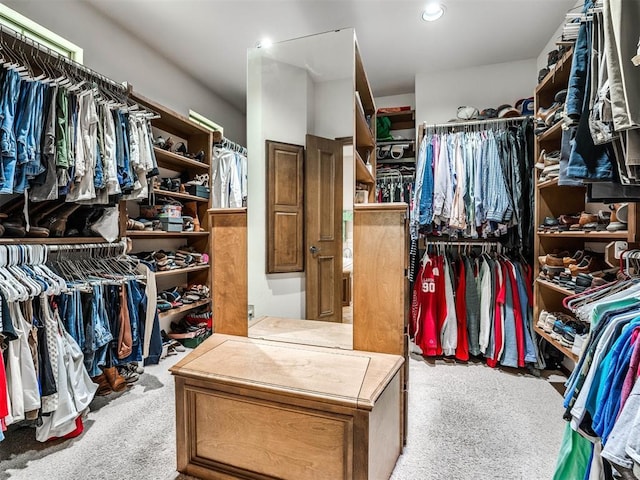 walk in closet with carpet floors