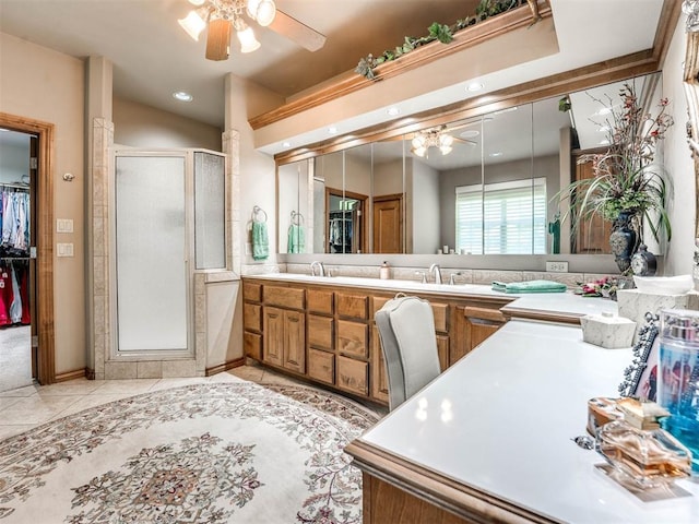 full bathroom with tile patterned floors, a shower stall, a ceiling fan, and double vanity