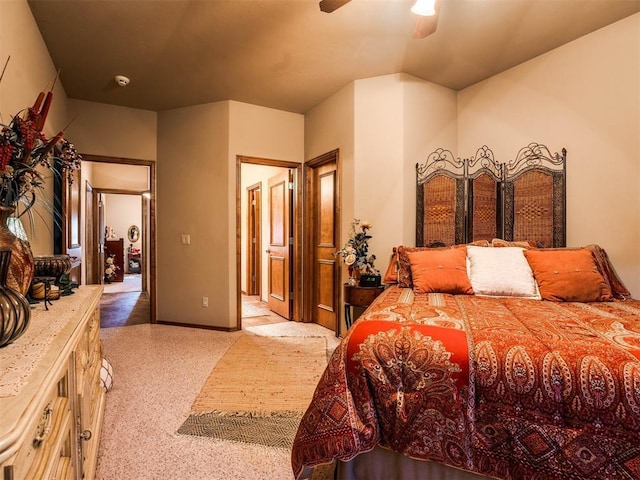 bedroom with light colored carpet and a ceiling fan
