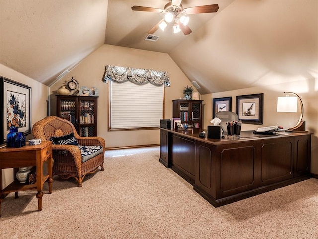 office area featuring lofted ceiling, ceiling fan, light colored carpet, and visible vents