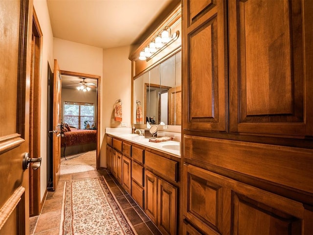 ensuite bathroom featuring double vanity, a sink, ceiling fan, and ensuite bath