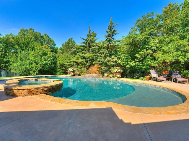 view of swimming pool featuring fence, a patio, and a pool with connected hot tub