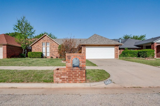 ranch-style house featuring a front yard, driveway, an attached garage, and brick siding