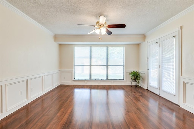 spare room with ceiling fan, a textured ceiling, dark wood-style flooring, and a decorative wall
