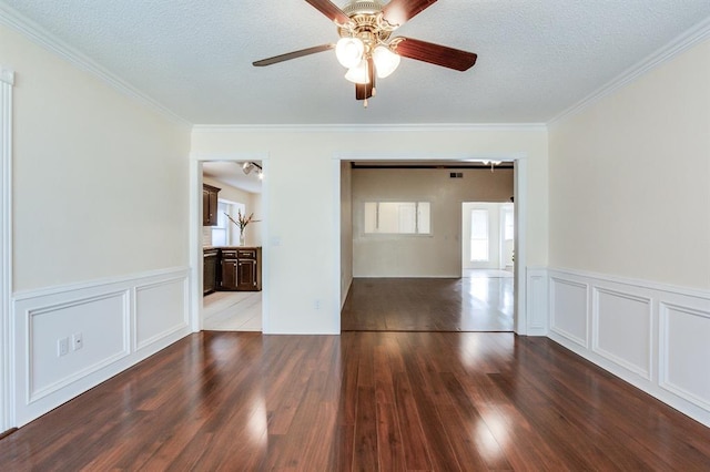 unfurnished room featuring wood finished floors, ceiling fan, a textured ceiling, and crown molding