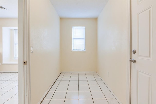 interior space featuring light tile patterned floors and visible vents