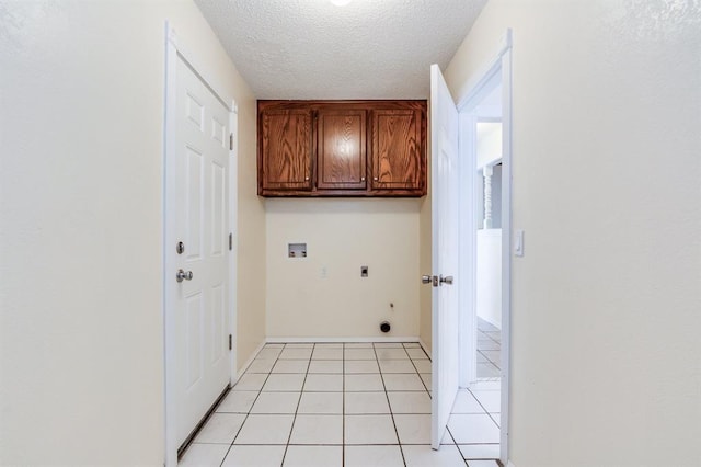 clothes washing area featuring cabinet space, light tile patterned flooring, washer hookup, electric dryer hookup, and a textured ceiling