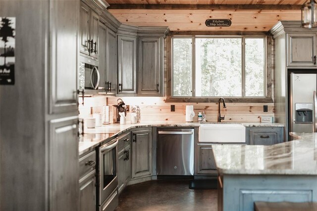 kitchen featuring stainless steel appliances, gray cabinetry, wooden ceiling, and a sink