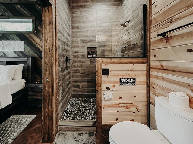 full bathroom with wooden walls, toilet, and a shower stall