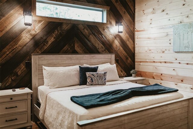 bedroom featuring wood walls