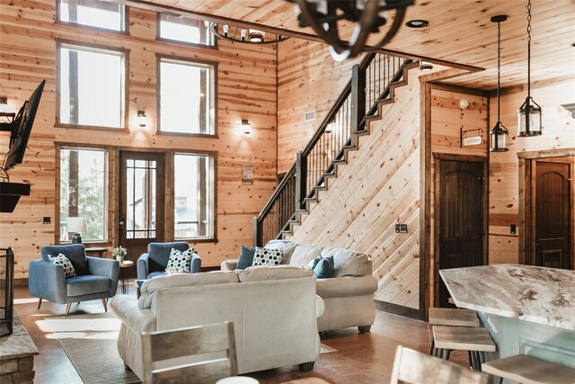living area featuring wooden ceiling, wood walls, and plenty of natural light
