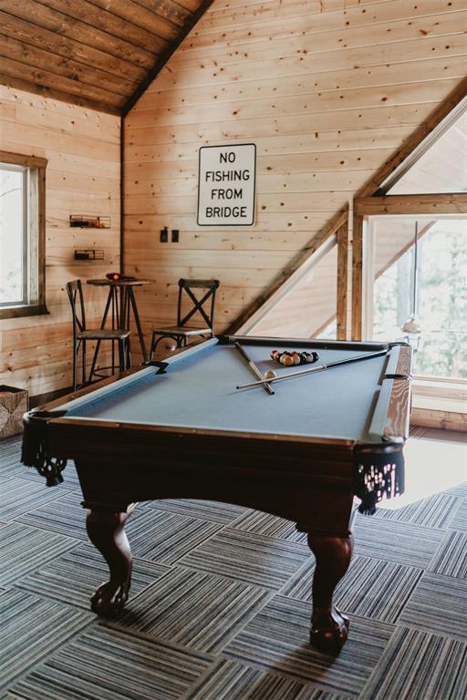 rec room featuring carpet floors, wooden walls, wooden ceiling, billiards, and vaulted ceiling