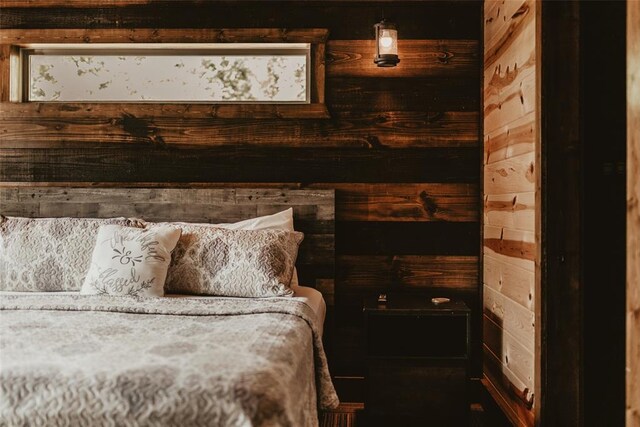 bedroom featuring wooden walls