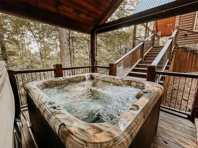 wooden terrace with stairs and a hot tub