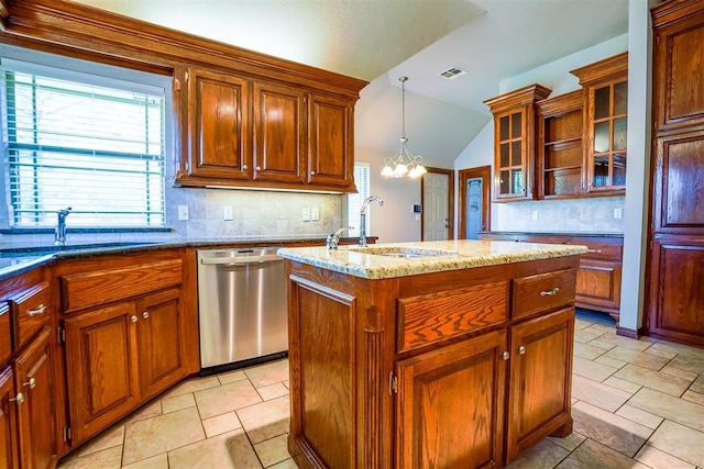 kitchen with a sink, stainless steel dishwasher, backsplash, and a center island with sink