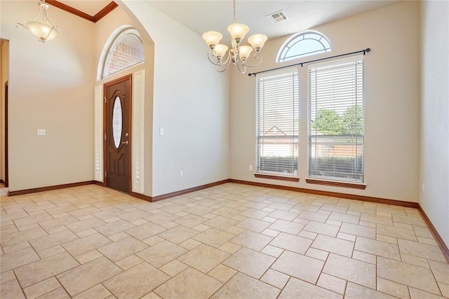 entrance foyer featuring an inviting chandelier, baseboards, arched walkways, and visible vents