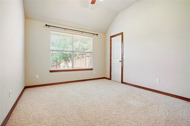 empty room with light carpet, ceiling fan, lofted ceiling, and baseboards
