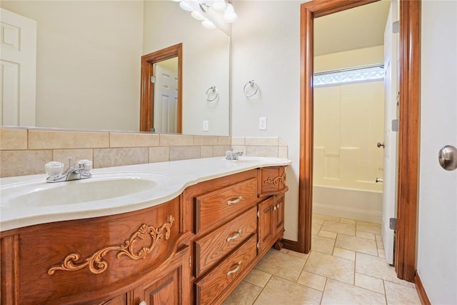bathroom with double vanity, baseboards, a tub to relax in, and a sink