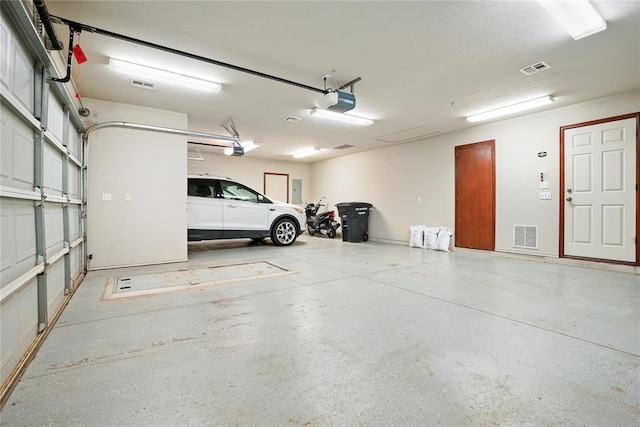 garage with visible vents and a garage door opener