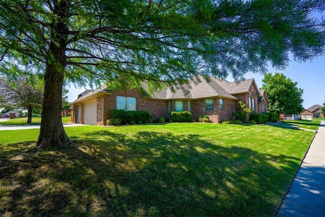 ranch-style home featuring driveway, an attached garage, brick siding, and a front yard