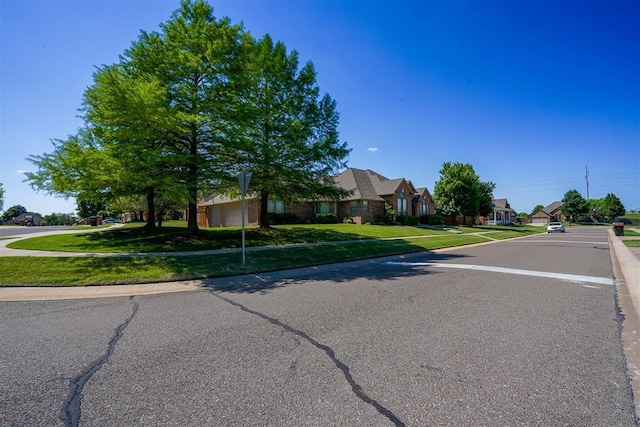 view of street with curbs, sidewalks, and a residential view