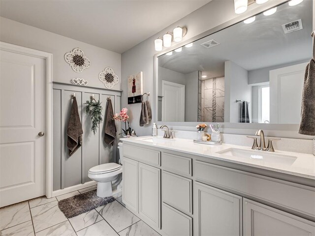 full bath featuring a sink, toilet, and visible vents