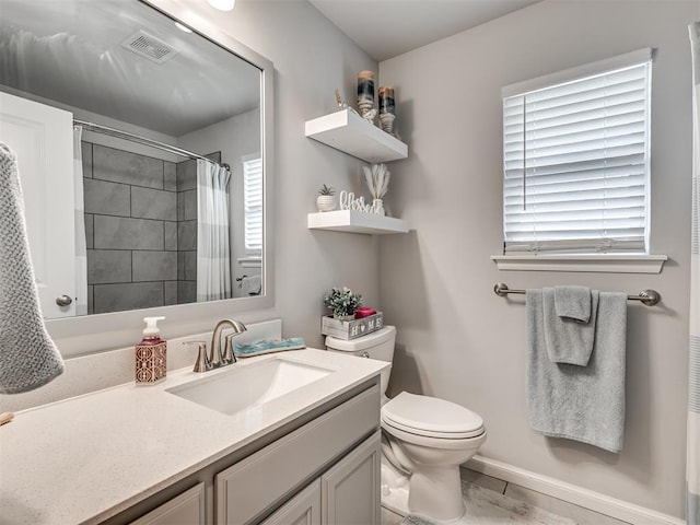 bathroom with visible vents, toilet, a shower with curtain, and vanity