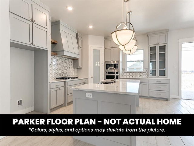 4120 Blue Ridge Ave, Newcastle, OK 73065 - kitchen featuring premium range hood, tasteful backsplash, stainless steel appliances, an island with sink, and pendant lighting