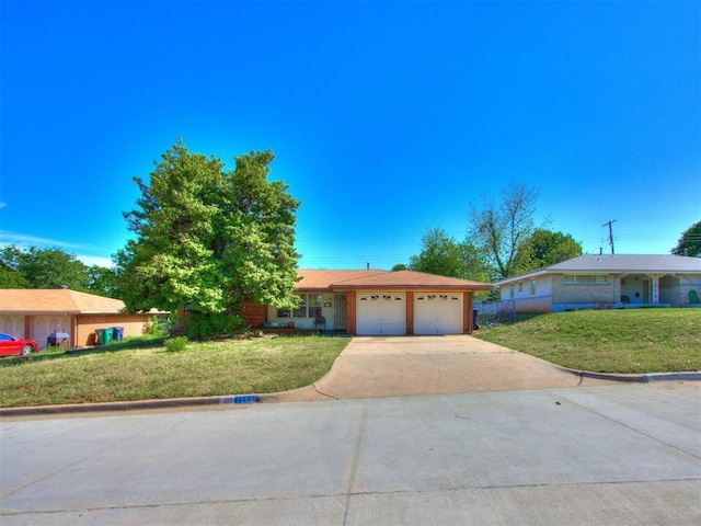 single story home with a front lawn, concrete driveway, and an attached garage