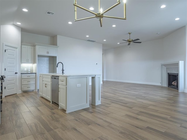 kitchen with visible vents, light wood-type flooring, open floor plan, and dishwasher