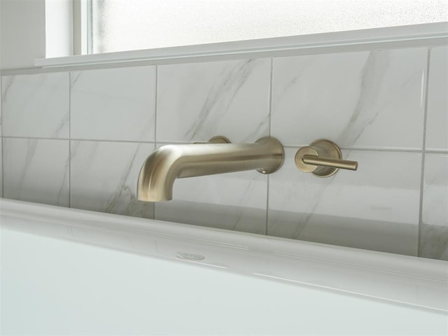 details featuring walk in shower and a sink