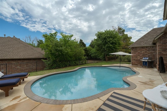 view of pool with area for grilling, a patio, a fenced in pool, and a fenced backyard