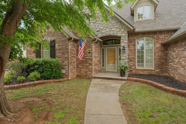 property entrance featuring brick siding and stone siding