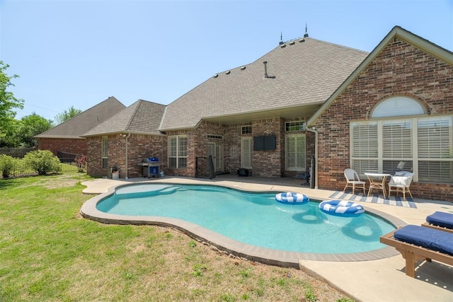 view of swimming pool with a patio area, fence, a fenced in pool, a yard, and a grill