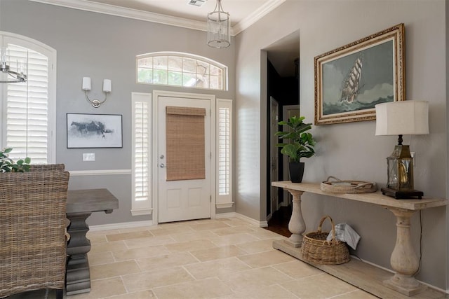 foyer entrance with baseboards, ornamental molding, and stone finish flooring