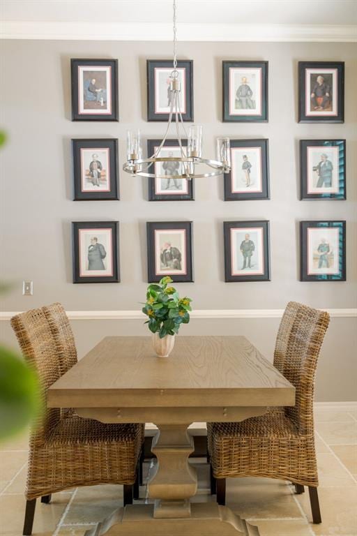 dining space featuring ornamental molding and a chandelier