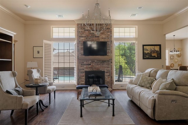 living area featuring crown molding, dark wood-type flooring, and a notable chandelier