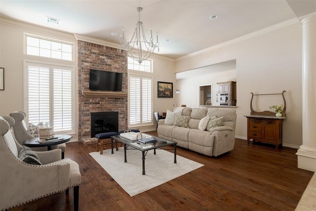 living area with a notable chandelier, dark wood finished floors, ornate columns, visible vents, and ornamental molding
