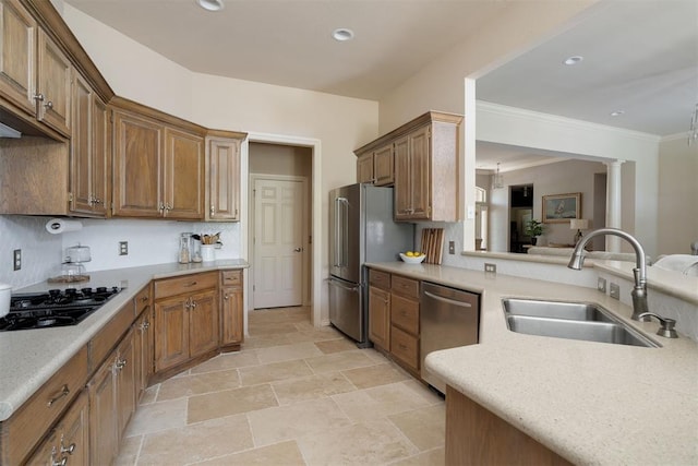 kitchen with stone finish floor, stainless steel appliances, recessed lighting, and a sink