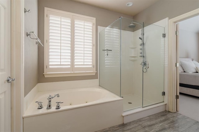 ensuite bathroom featuring a tub with jets, ensuite bathroom, and a shower stall