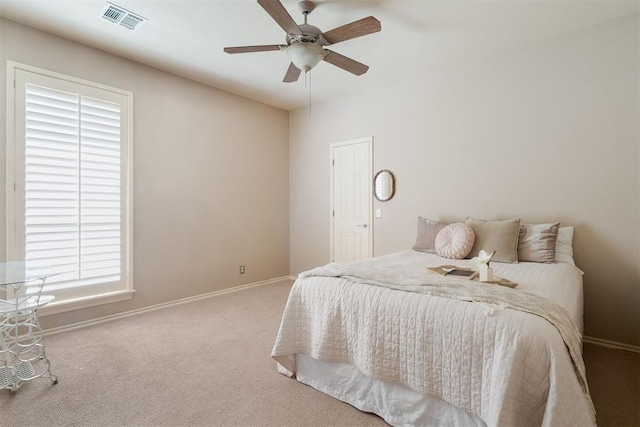 bedroom featuring carpet floors, a ceiling fan, baseboards, and visible vents