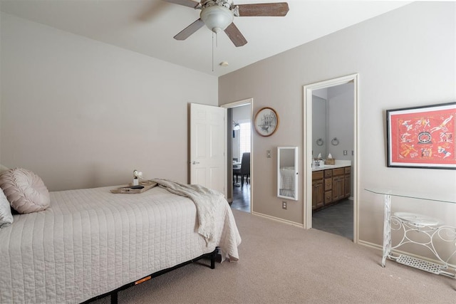 carpeted bedroom featuring ensuite bathroom, baseboards, and ceiling fan
