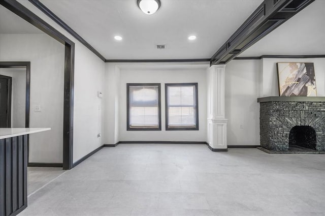 unfurnished living room featuring recessed lighting, a fireplace, crown molding, baseboards, and ornate columns