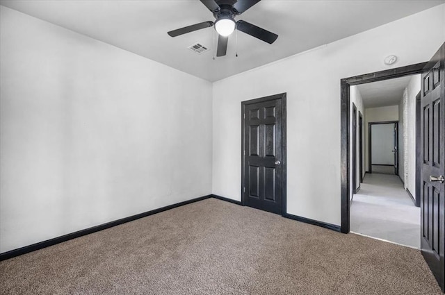 unfurnished bedroom with visible vents, ceiling fan, carpet floors, and baseboards