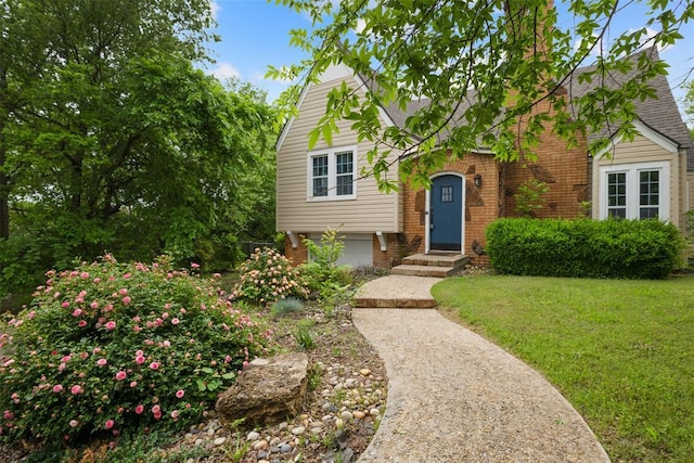 1201 E 18th St, Ada, OK 74820 - view of front of property with brick siding, roof with shingles, and a front yard