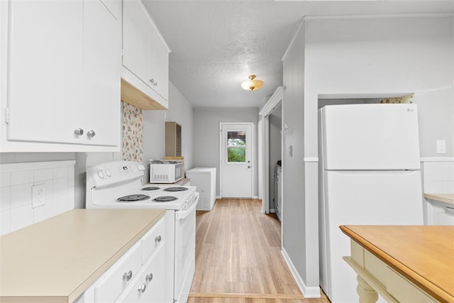 1201 E 18th St, Ada, OK 74820 - kitchen with light wood-type flooring, light countertops, white cabinetry, and white appliances