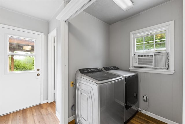 1201 E 18th St, Ada, OK 74820 - clothes washing area featuring laundry area, wood finished floors, washing machine and dryer, baseboards, and cooling unit