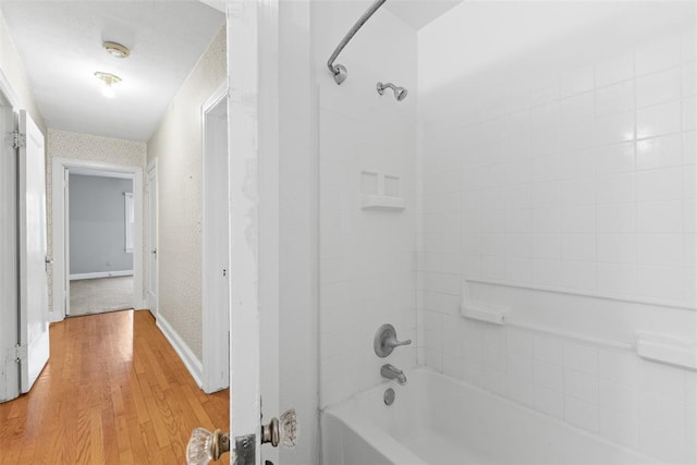 1201 E 18th St, Ada, OK 74820 - full bathroom featuring baseboards, shower / tub combination, and wood finished floors