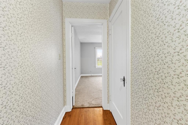 1201 E 18th St, Ada, OK 74820 - hallway featuring baseboards, wallpapered walls, and wood finished floors