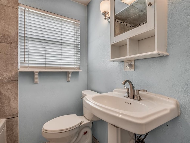 bathroom featuring toilet and a sink